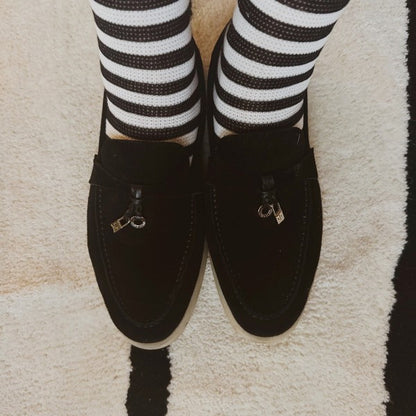 Woman wearing black and white striped Urban Stripes Socks paired with casual shoes.