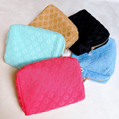 Flat lay of all Embossed Daisy Blossom Cosmetic Cases arranged side by side.