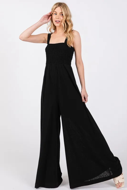 Fashionable Black Jumpsuit with Smocked Bodice and Wide Leg Design, Perfect for Casual to Semi-Formal Events.