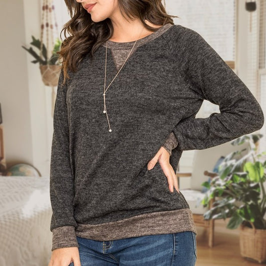 Casual black tunic with long raglan sleeves, round neck, and two-tone design.