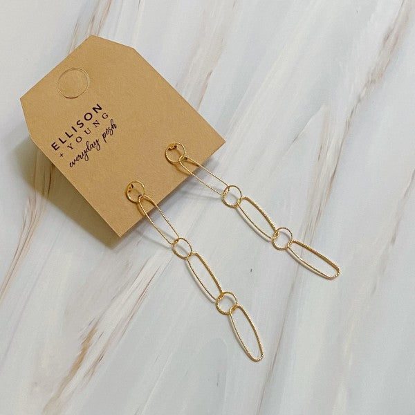 Gold chain link drop earrings displayed on Ellison + Young branded packaging