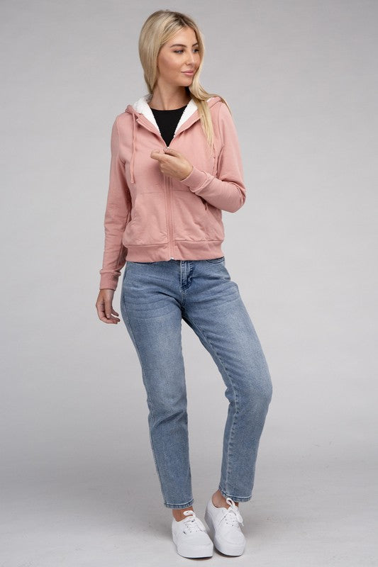 Mauve cropped zip-up hoodie with fuzzy trim, pockets, and long sleeves.