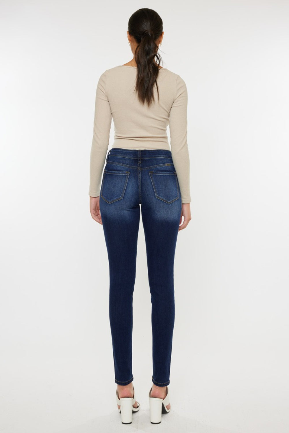 Mid rise gradient skinny jeans with a dark wash. Slightly stretchy, with pockets and a zip fly closure.