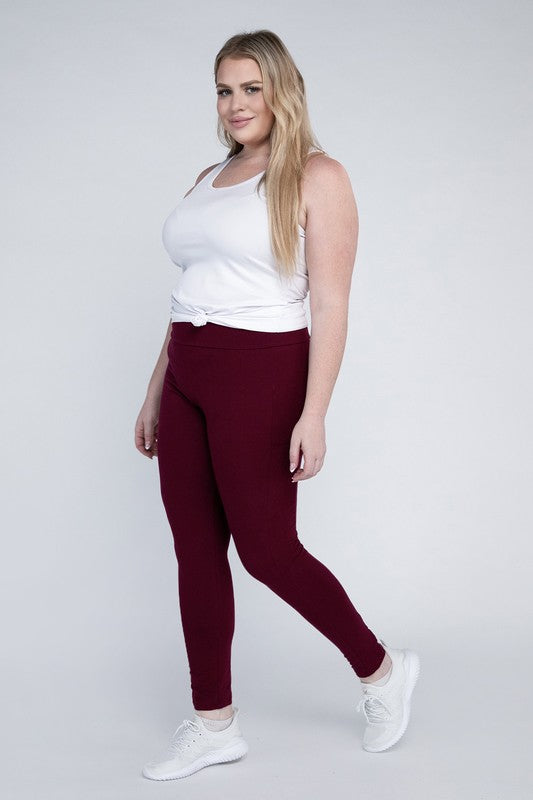 Full-length curvy plus leggings in dark burgandy with a high-rise thick waistband, fitted silhouette, and convenient leg pockets.