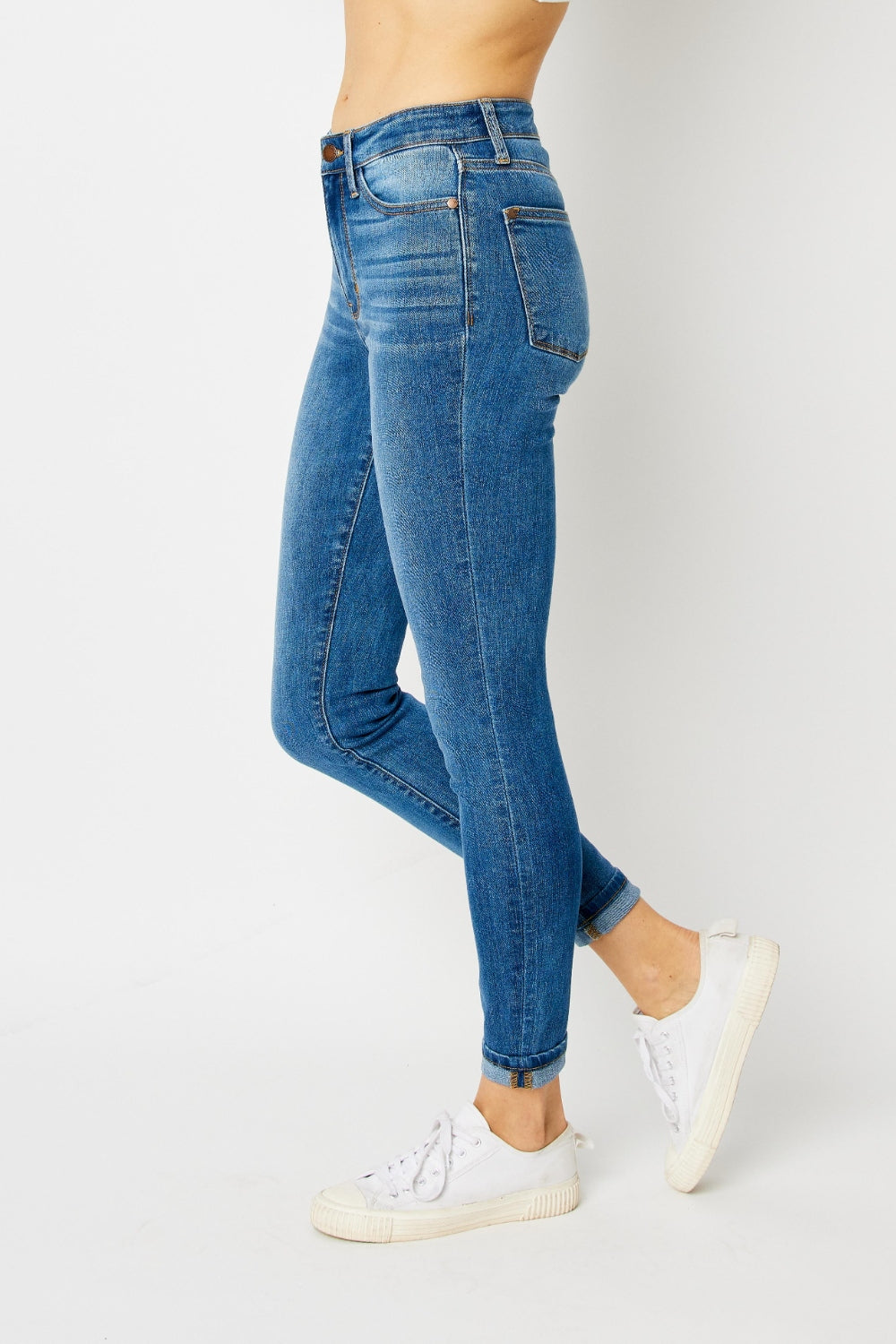 Mid-rise skinny jeans with cuffed hems and a zip fly. Medium wash with a slim fit and highly stretchy fabric.