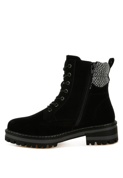 Side view of Black Mahisha Hiker Boots showing lug sole, chunky heel, and knitted collar contrast.