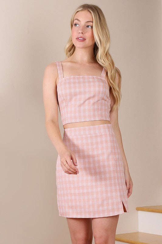 Pink checkered square neck crop top and high-waist mini skirt with side slit and smocked details.