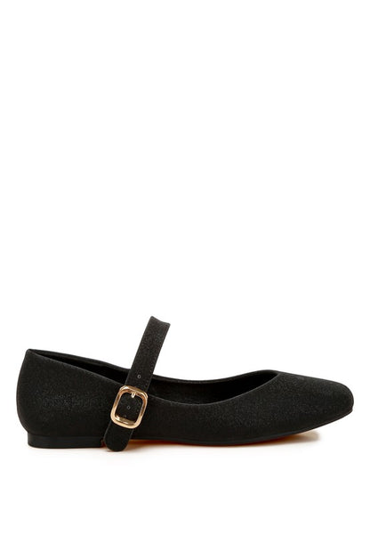 Side angle of black glitter ballerinas with pin buckle strap and flat heel.