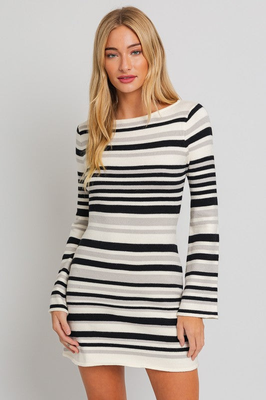 Black and white striped sweater dress with a boat neckline, long bell sleeves, and a mini length.