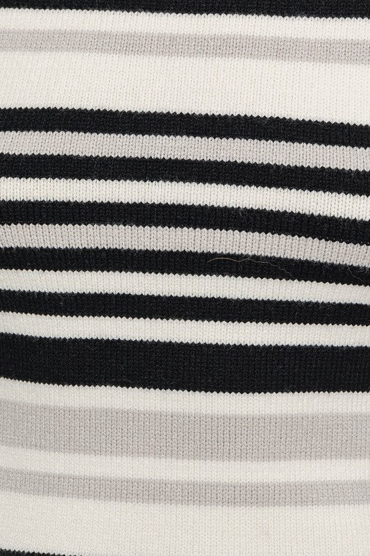 Black and white striped sweater dress with a boat neckline, long bell sleeves, and a mini length.