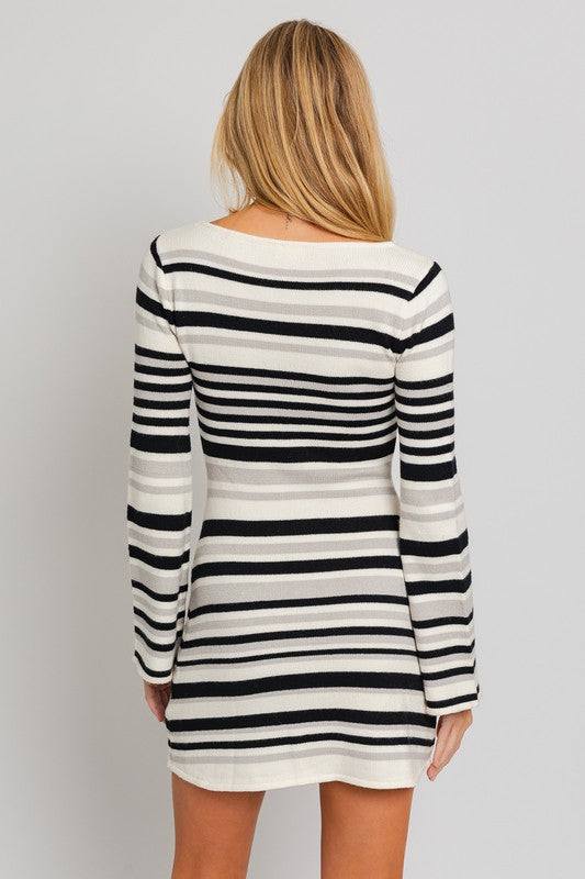 Black and white striped sweater dress with a boat neckline, long bell sleeves, and a mini length.