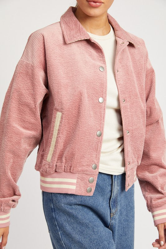 Rose pink Zita Bomber Jacket with white accents, snap buttons, and a cozy collar, offering a lightweight, feminine style for casual outfits.