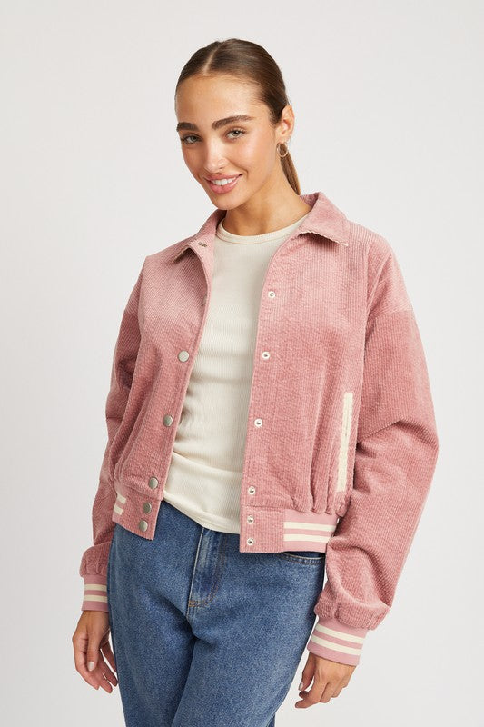 Rose pink Zita Bomber Jacket with white accents, snap buttons, and a cozy collar, offering a lightweight, feminine style for casual outfits.