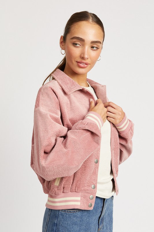 Rose pink Zita Bomber Jacket with white accents, snap buttons, and a cozy collar, offering a lightweight, feminine style for casual outfits.