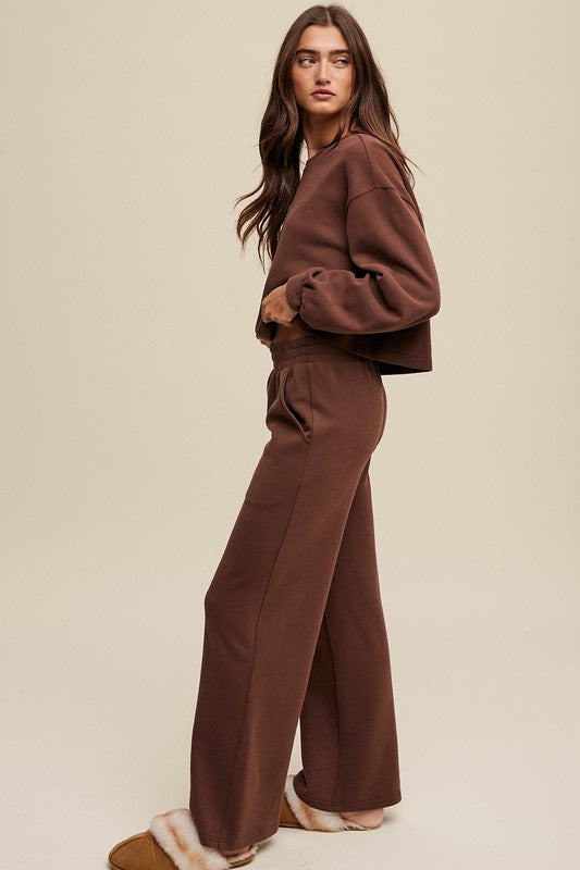 Cozy mocha knit sweat top with round neck and long sleeves paired with wide-leg mocha pants featuring an elastic waist and pockets.