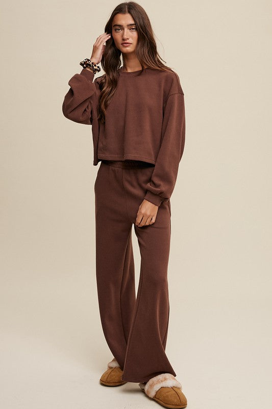 Cozy mocha knit sweat top with round neck and long sleeves paired with wide-leg mocha pants featuring an elastic waist and pockets.