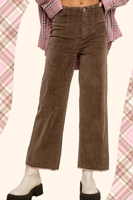 Brown mineral-washed corduroy wide-leg ankle-length jeans with raw-edge hem, front dart detail, zip fly, and back pockets.