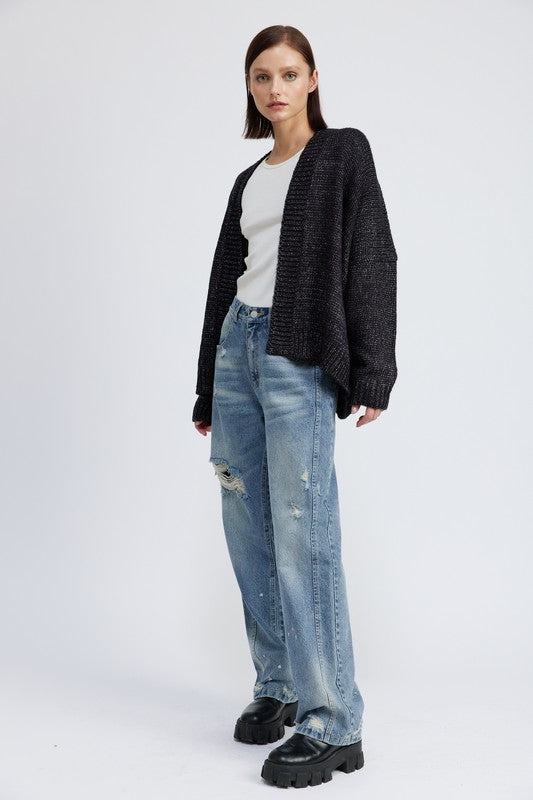 Full body view of model in Elistina Oversized Cardigan styled with jeans and boots.