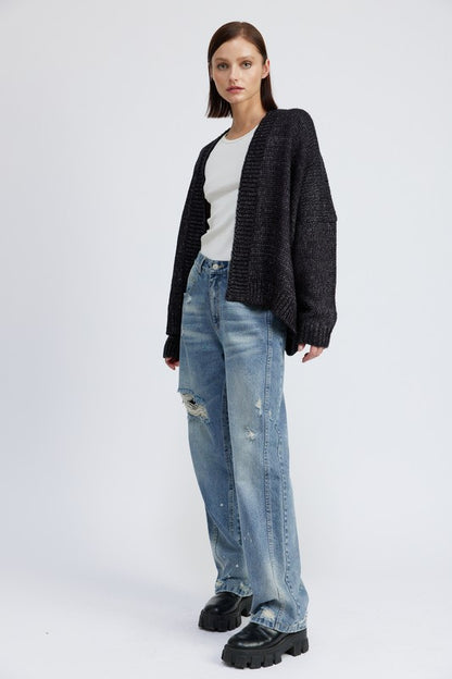 Full body view of model in Elistina Oversized Cardigan styled with jeans and boots.