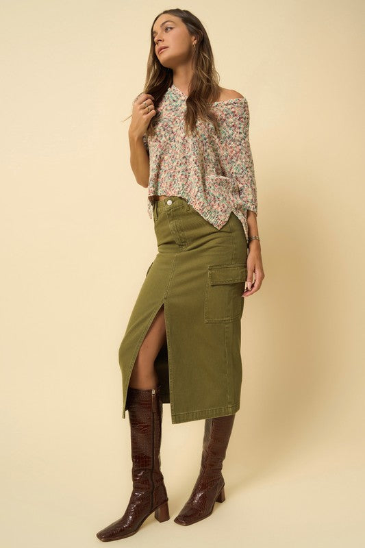 Olive green denim cargo midi skirt with a front slit and seven functional pockets. Features a button closure and regular fit.