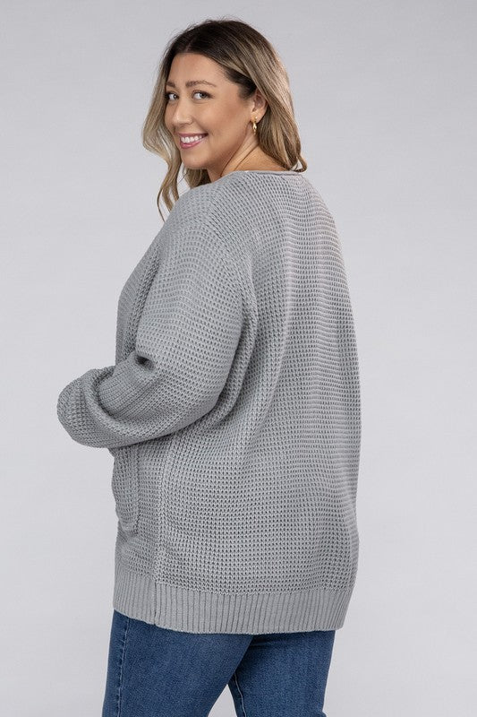 Curvy plus-size waffle-pattern open cardigan sweater in light grey, with long sleeves, oversized fit, and pockets.