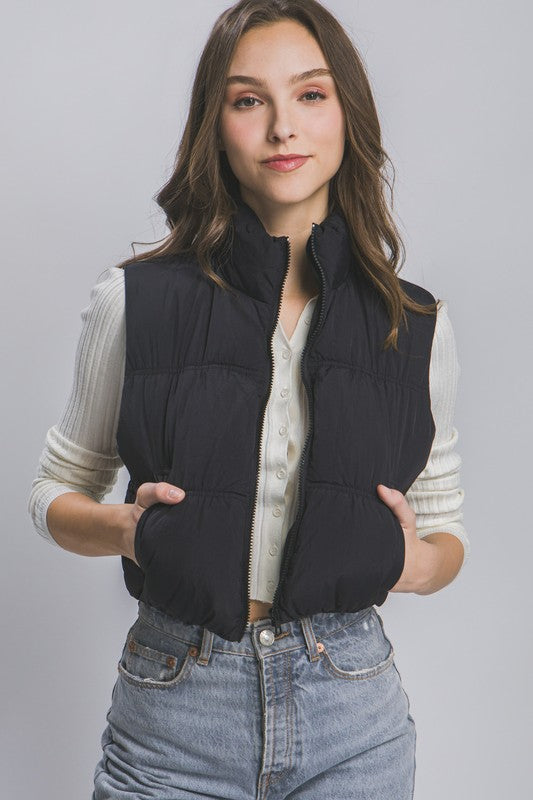 Balck sleeveless puffer vest with a high collar, cropped length, and side pockets.