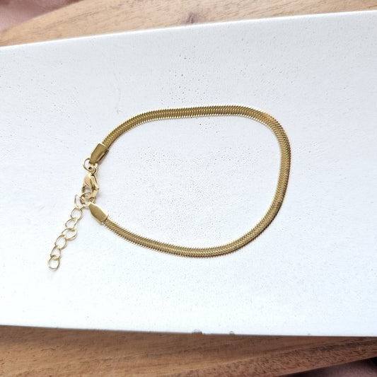 Kadence Gold Herringbone Bracelet displayed on a white background, showing sleek flat chain design.
