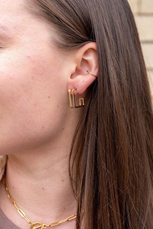 Woman wearing Kamora Gold Hoop Earrings, sleek gold , geometric hoops.