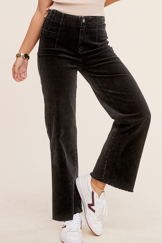 Black mineral-washed corduroy wide-leg ankle-length jeans with raw-edge hem, front dart detail, zip fly, and back pockets.