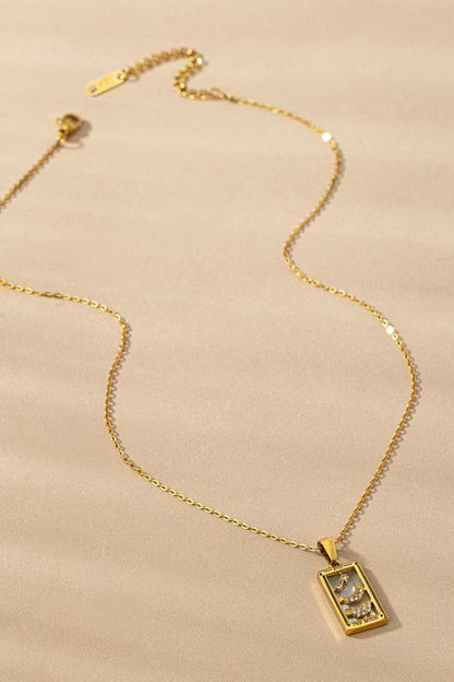 Tarot Card Moon Pendant Necklace with black onyx background and crescent moon design on gold-tone chain.