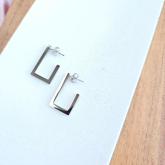 Goldi Luxe Silver Square Hoop Earrings on white background, stainless steel, modern geometric design.