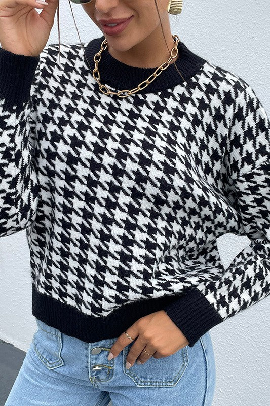 Front angled view of Delaney Black Houndstooth Sweater styled with jeans