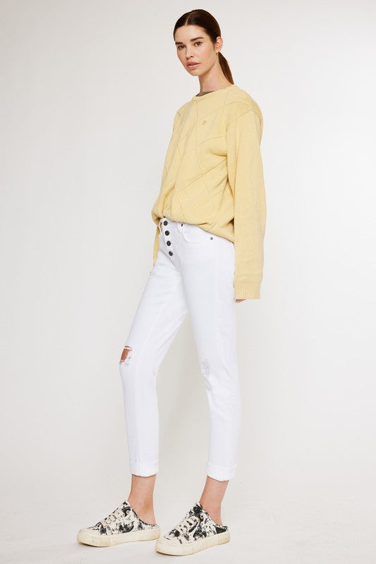 White, distressed, stretch girlfriend fit, ankle-length, jeans with a mid-rise waist and button fly closure.