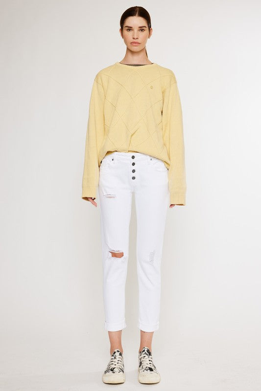 White, distressed, stretch girlfriend fit, ankle-length, jeans with a mid-rise waist and button fly closure.