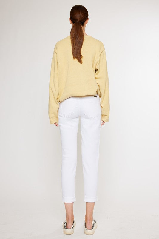 White, distressed, stretch girlfriend fit, ankle-length, jeans with a mid-rise waist and button fly closure.