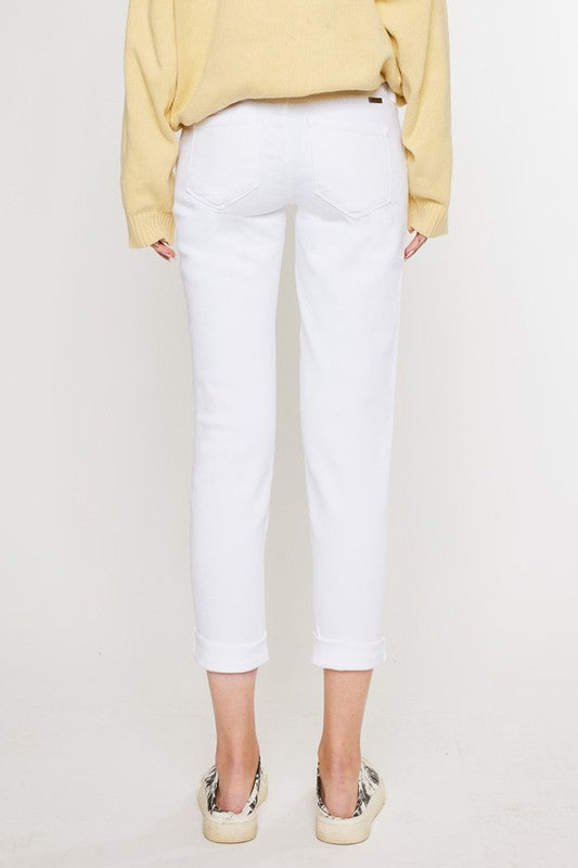 White, distressed, stretch girlfriend fit, ankle-length, jeans with a mid-rise waist and button fly closure.