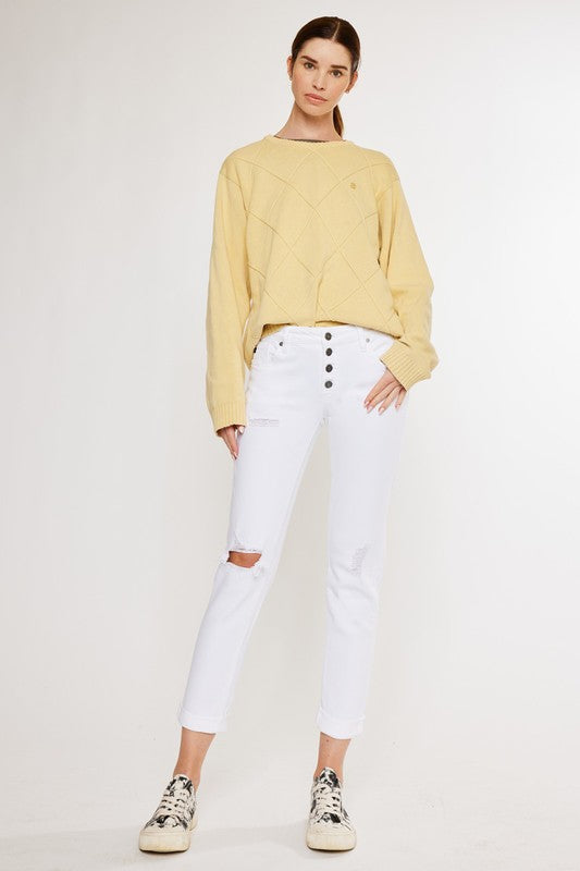 White, distressed, stretch girlfriend fit, ankle-length, jeans with a mid-rise waist and button fly closure.