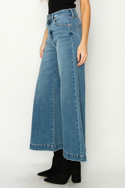 Medium stone wash high-rise crop palazzo jeans with wide hems and a slightly stretchy denim. 