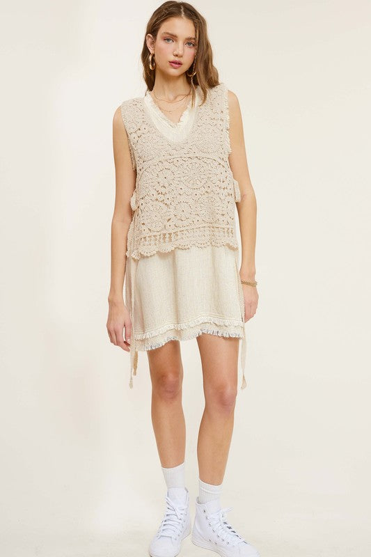 Sleeveless crochet vest with scoop neckline and side self-tie details.