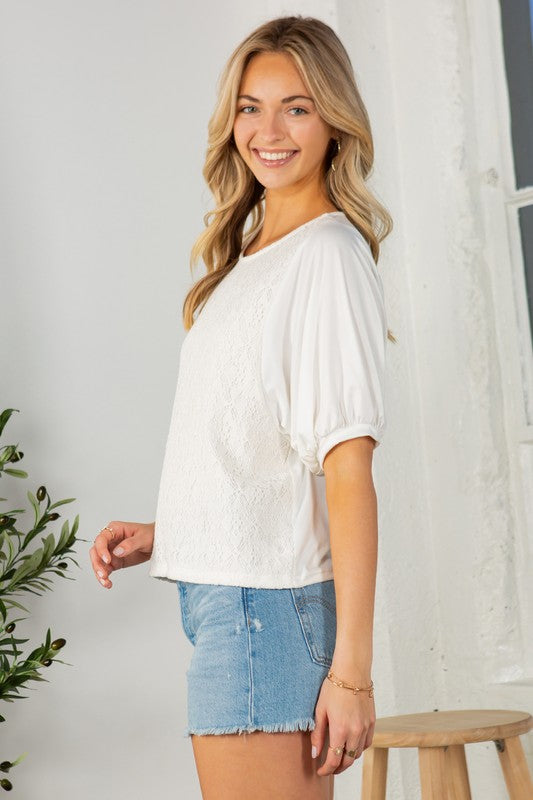 Off white lace overlay top with puff sleeves, a crew neckline, and a regular fit