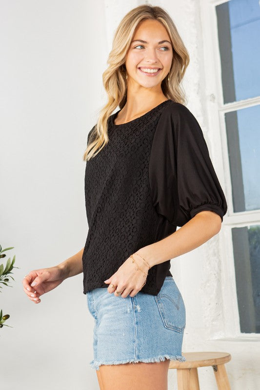 Black lace overlay top with puff sleeves, a crew neckline, and a regular fit