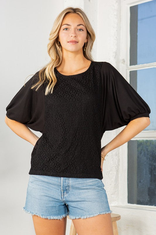 Black lace overlay top with puff sleeves, a crew neckline, and a regular fit