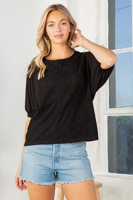 Black lace overlay top with puff sleeves, a crew neckline, and a regular fit