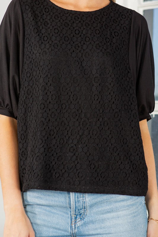 Black lace overlay top with puff sleeves, a crew neckline, and a regular fit