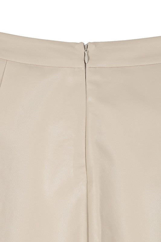 Ivory vegan leather pleated mini skirt with 4 pin tucks on the front and back for added style. Features a zipper closure.