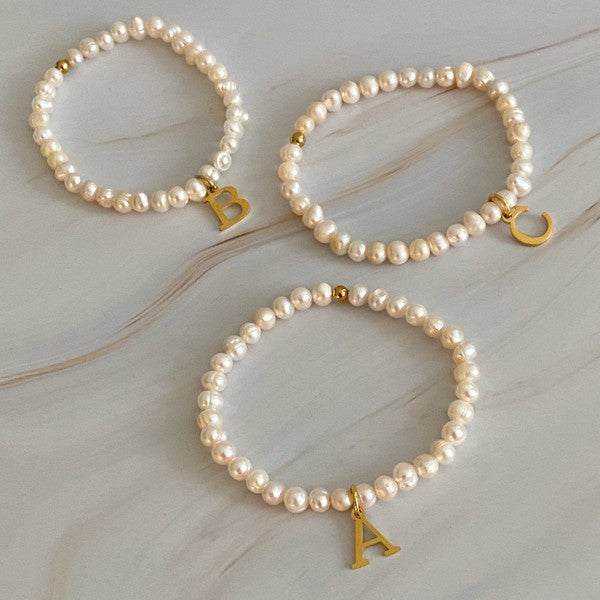 Freshwater Pearl Initial Charm Bracelet featuring genuine freshwater pearls and a gold-plated initial charm, approximately 6.5" before stretch.