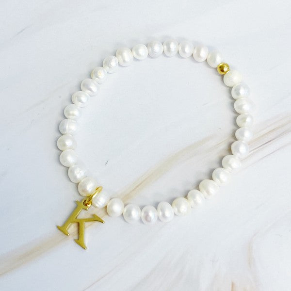 Freshwater Pearl Initial Charm Bracelet featuring genuine freshwater pearls and a gold-plated letter K initial charm, approximately 6.5" before stretch.