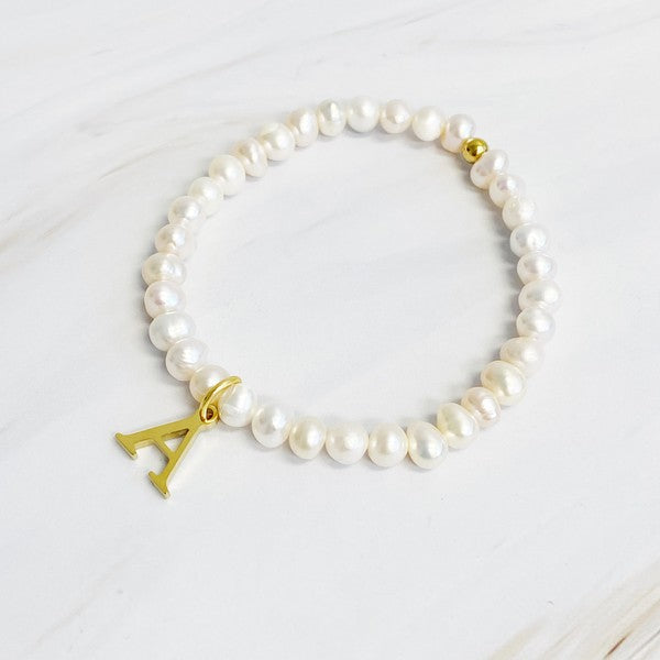 Freshwater Pearl Initial Charm Bracelet featuring genuine freshwater pearls and a gold-plated letter A initial charm, approximately 6.5" before stretch.