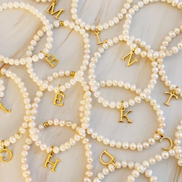 Freshwater Pearl Initial Charm Bracelet featuring genuine freshwater pearls and a gold-plated initial charm, approximately 6.5" before stretch.