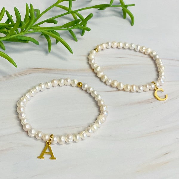 Freshwater Pearl Initial Charm Bracelet featuring genuine freshwater pearls and a gold-plated initial charm, approximately 6.5" before stretch.